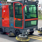 Battery-powered industrial sweeper in action