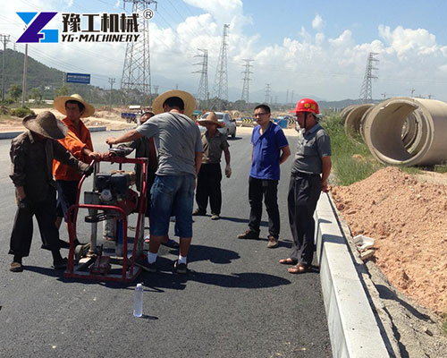 Hydraulic core drill extracting road sample