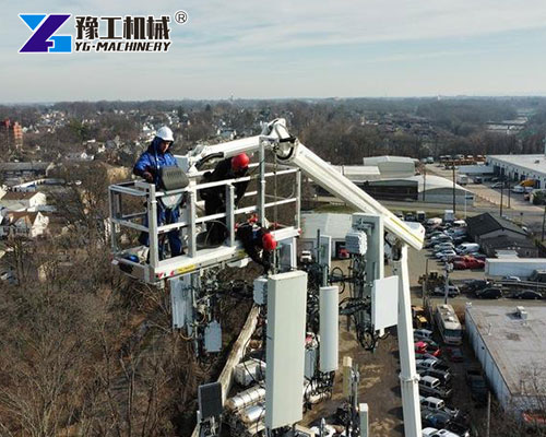 Knuckle Boom Lift parked next to telecom tower for maintenance
