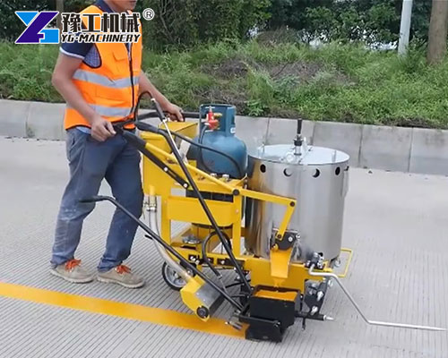 Worker operating Glass Beads Road Marking Machine