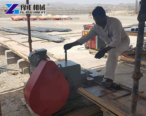 Worker using automatic steel bar cutter