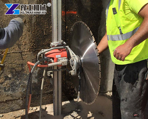 Workers using concrete wall cutting machine
