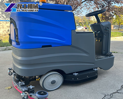 Battery-powered ride-on floor sweeper in use