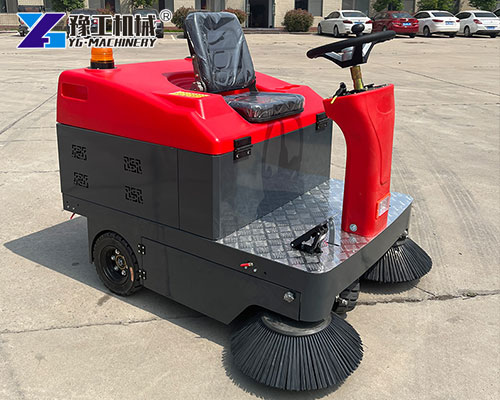 Commercial ride on sweeper cleaning warehouse