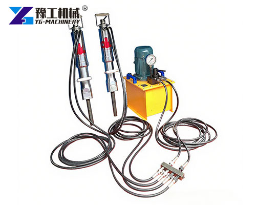 Electric rock splitter breaking concrete foundation