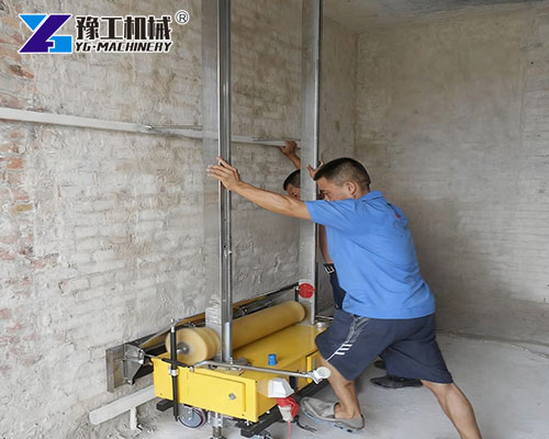 Skilled worker monitoring wall plastering machine