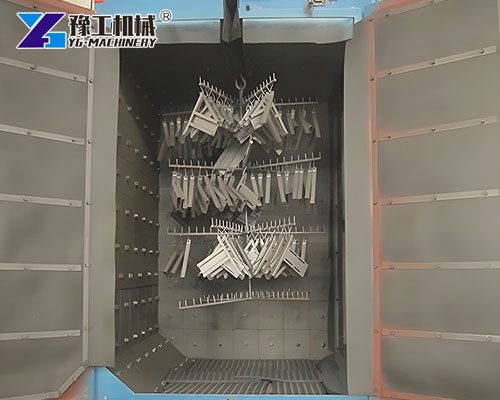 Steel parts inside hook-type shot blasting chamber