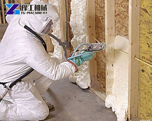 Worker using polyurethane foam spray machine