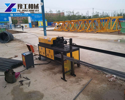 Workers operating steel bar straightening and cutting machine
