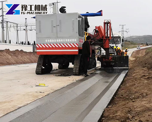 Concrete curb forming machine working on site
