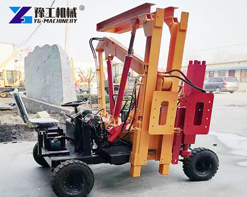 Highway guardrail pile driver working on job site